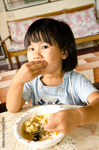 Little asian girl eating her lunch