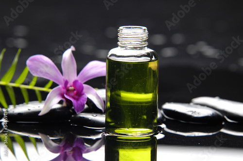 massage oil and fern with orchid reflection