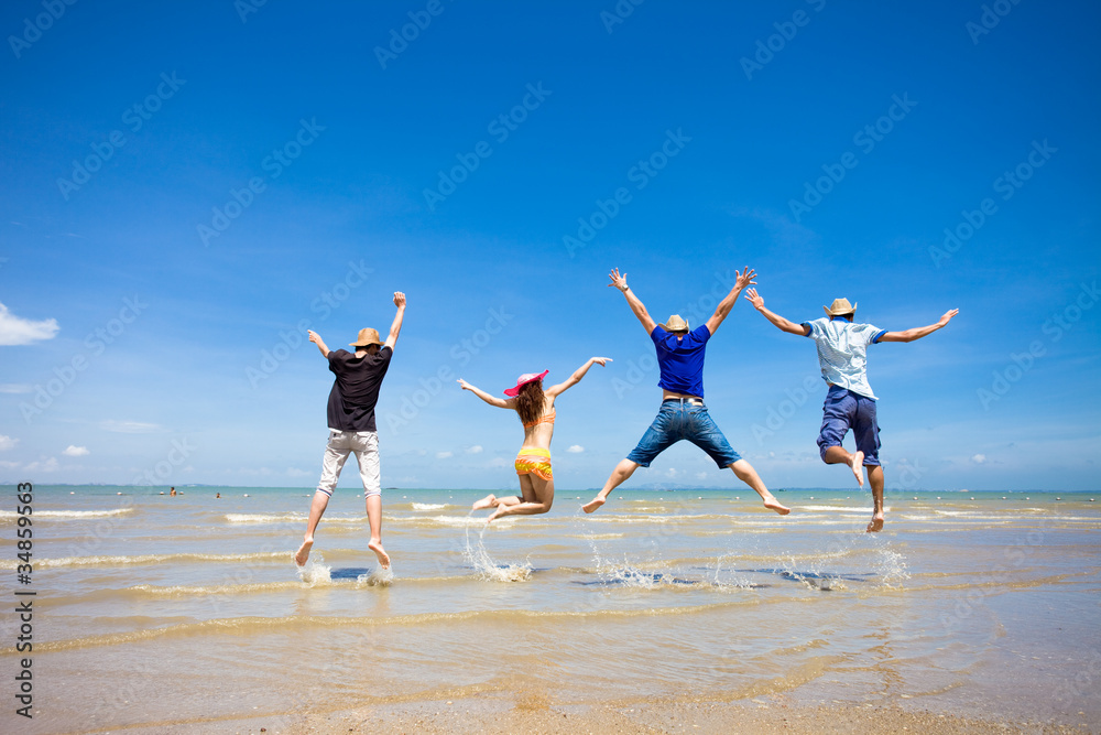 people jumping at the beach