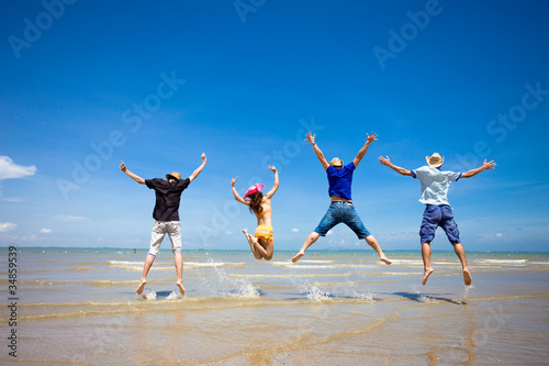 people jumping at the beach