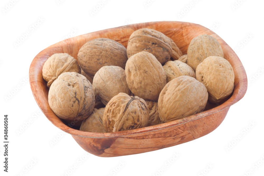 Whole walnuts in wooden plate. isolated on white. Whole walnuts in wooden plate. isolated on white.