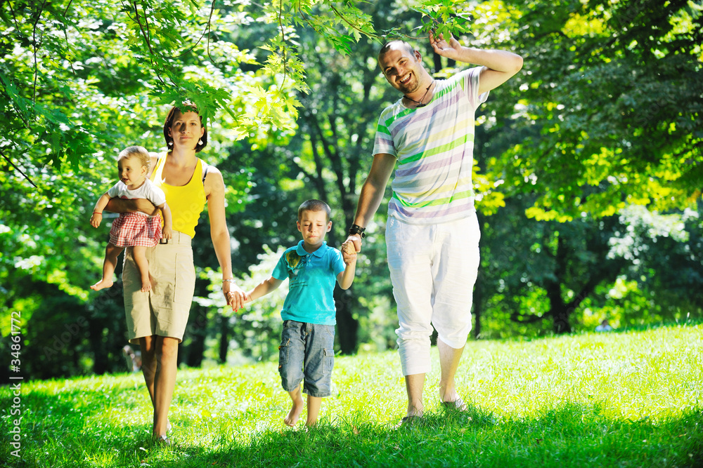 happy young couple with their children have fun at park