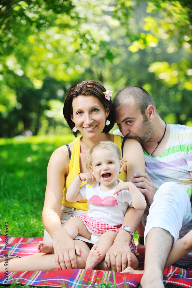 happy young couple with their children have fun at park happy young couple with their children have fun at park