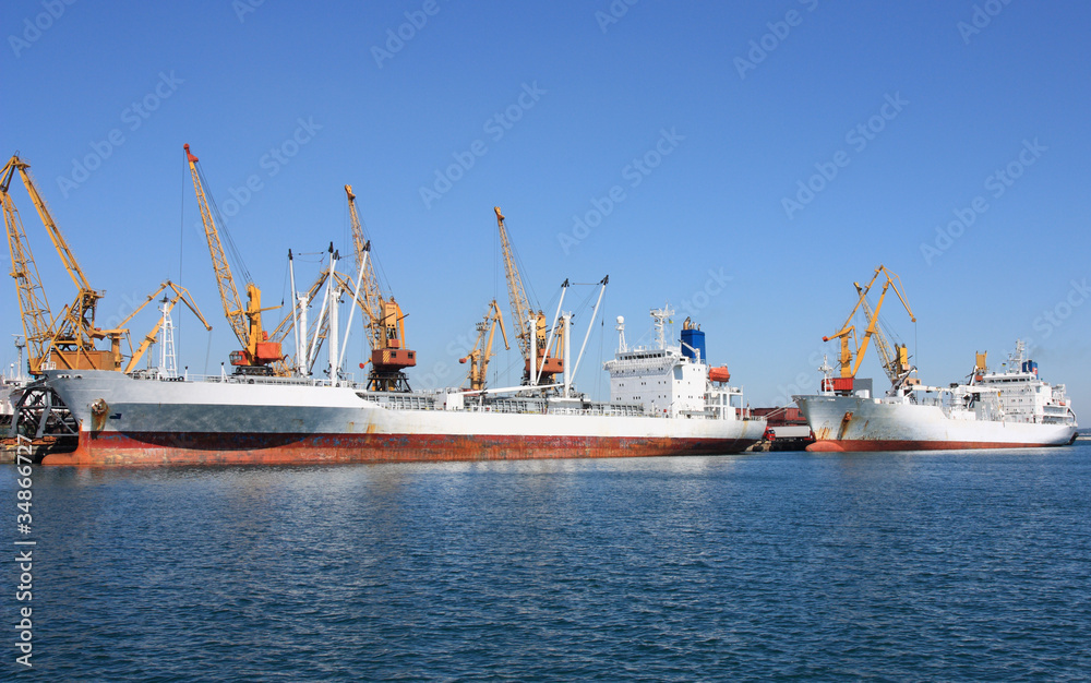 trading seaport with cranes and cargo ships