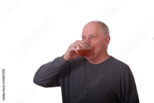 Older Balding Man in Gray Shirt Drinking Iced Tea