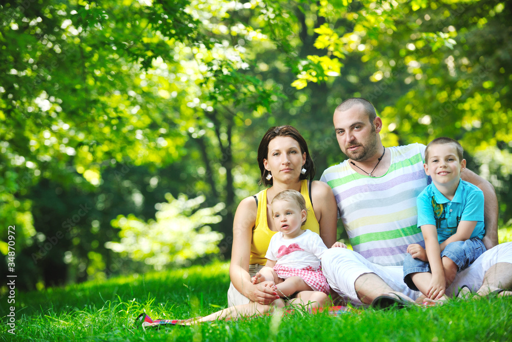 happy young couple with their children have fun at park happy young couple with their children have fun at park