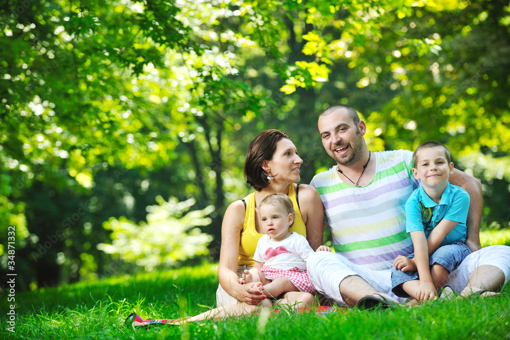 Fototapeta premium happy young couple with their children have fun at park
