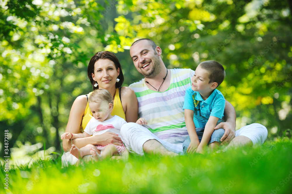 happy young couple with their children have fun at park happy young couple with their children have fun at park