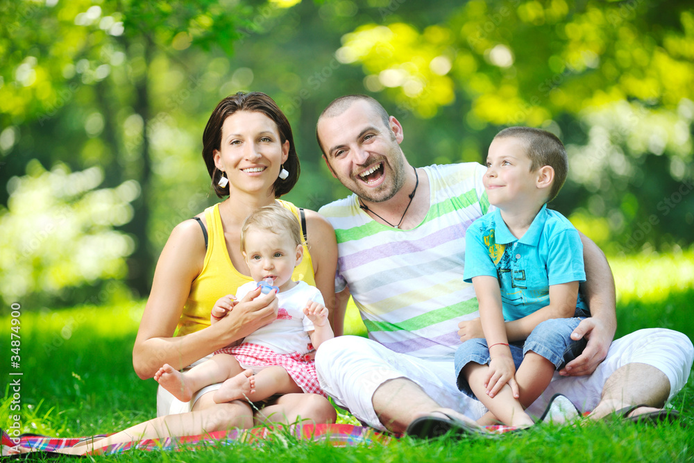 happy young couple with their children have fun at park happy young couple with their children have fun at park