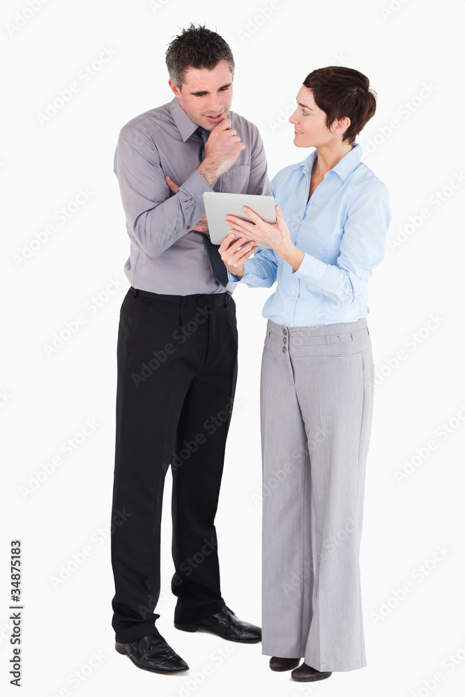 Office workers looking at a tablet computer