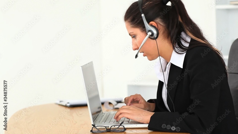 Businesswoman with a headset and a laptop Businesswoman with a headset and a laptop