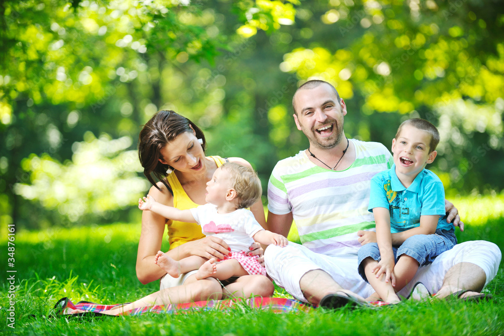 happy young couple with their children have fun at park happy young couple with their children have fun at park