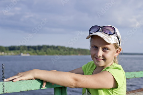 Portrait of little girl standing on the ferry boat photo