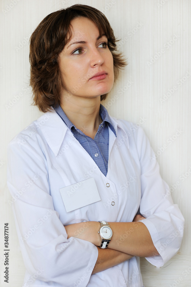Portrait of a female doctor against white wall Portrait of a female doctor against white wall