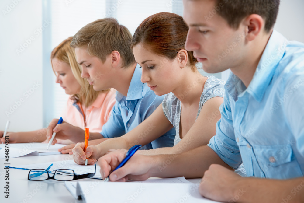 group of students studying together in a classroom group of students studying together in a classroom