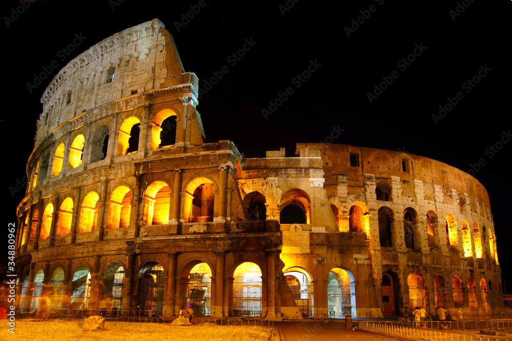 Colosseum under the glow of lights at night, Rome