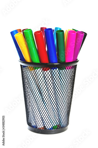 Colored markers in a cup.