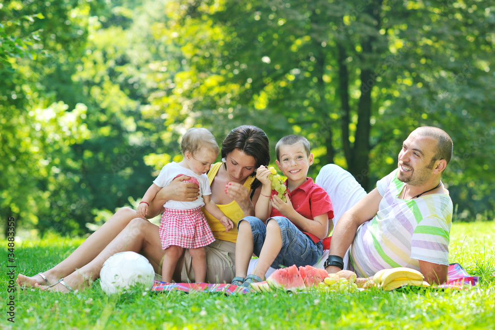 happy young couple with their children have fun at park happy young couple with their children have fun at park