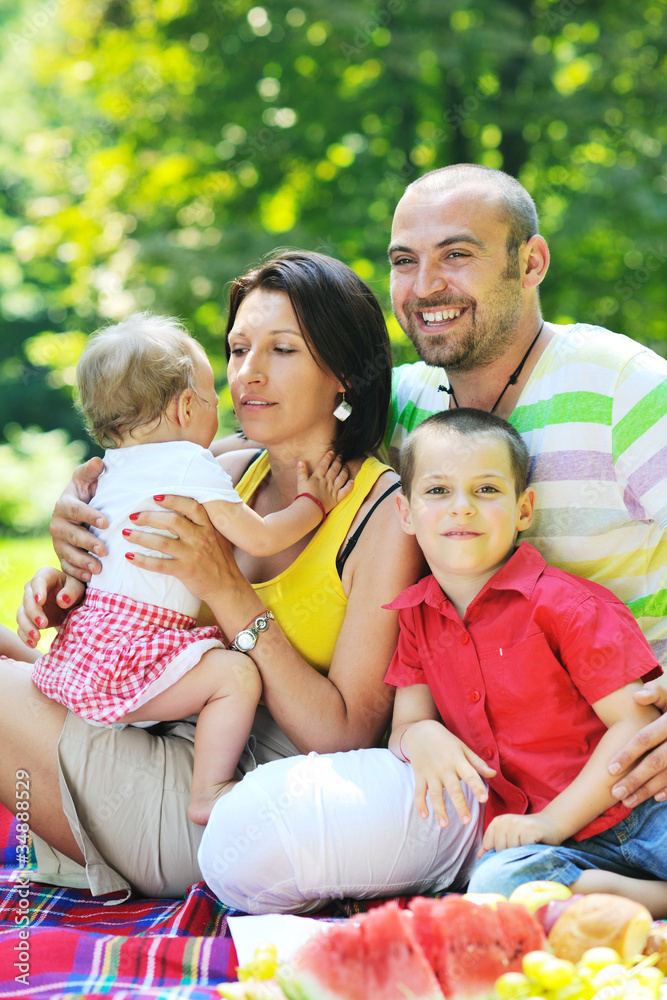 Fototapeta premium happy young couple with their children have fun at park