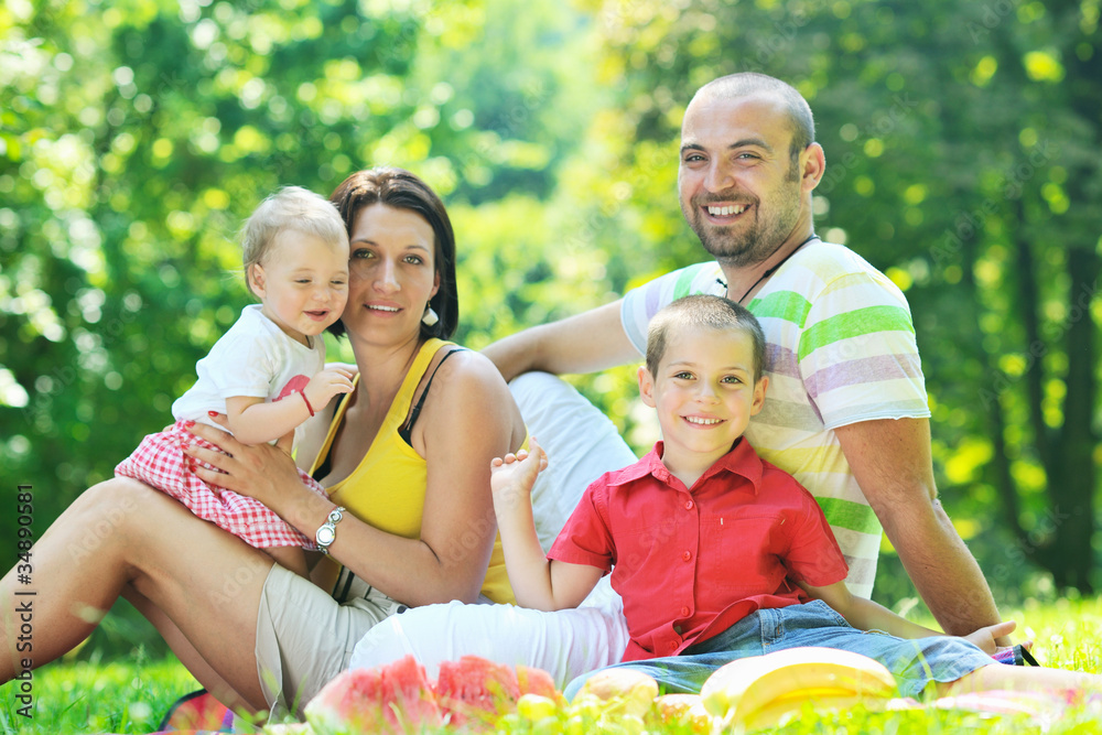 happy young couple with their children have fun at park happy young couple with their children have fun at park
