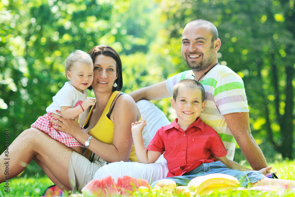 happy young couple with their children have fun at park