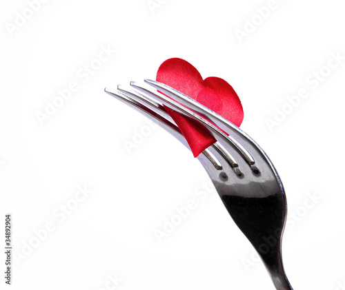 Red plug and knife near heart symbol photo