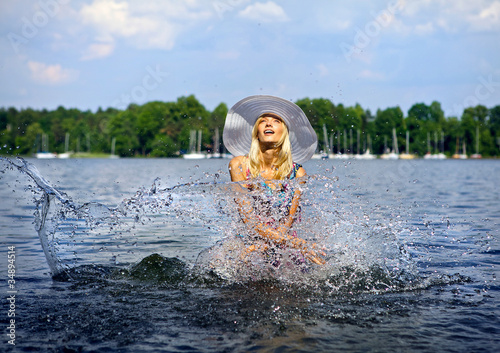 Fototapeta Naklejka Na Ścianę i Meble -  Beautiful blond model standing on water.