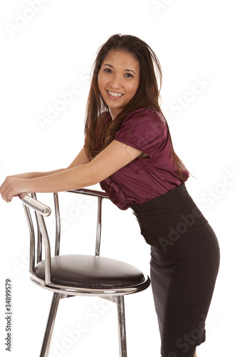 woman leaning on stool smile