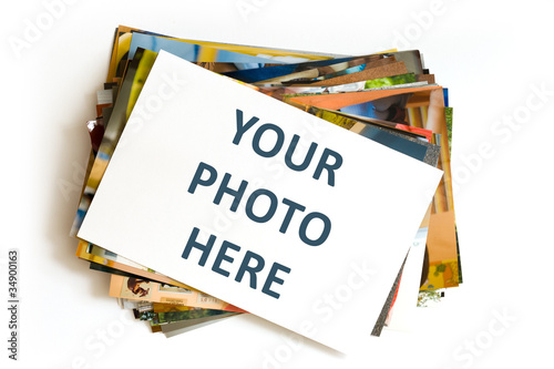 Pile of photographs with empty frame