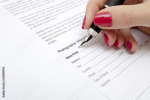 Female hand signing contract
