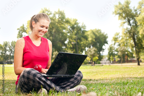 woman using laptop in park