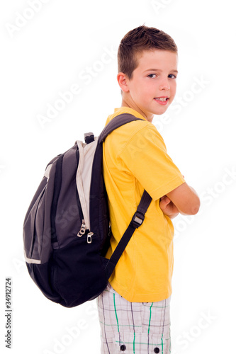 Portrait of school boy standing with scholl bag, isolated on whi