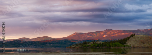 Distant Yukon mountains glowing in sunset light
