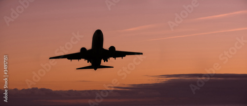 Airplane on sunset sky © byggarn.se