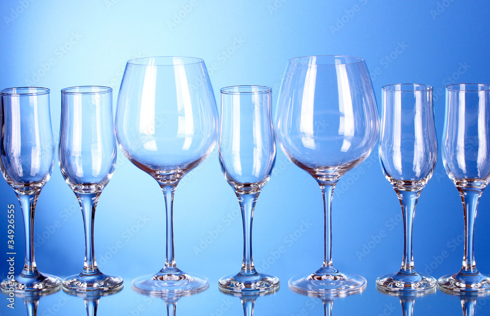 Few empty wine glasses on blue background