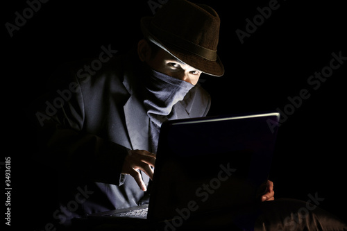 Masked man stealing sensitive information