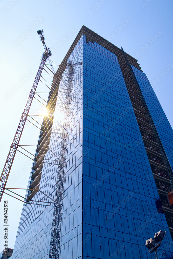 Fototapeta premium Building crane and building under construction