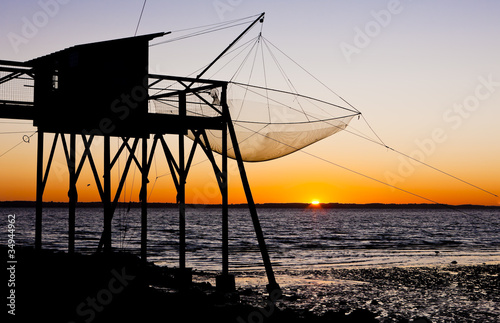 Fototapeta Naklejka Na Ścianę i Meble -  pier with fishing net during sunrise, Gironde Department, Aquita