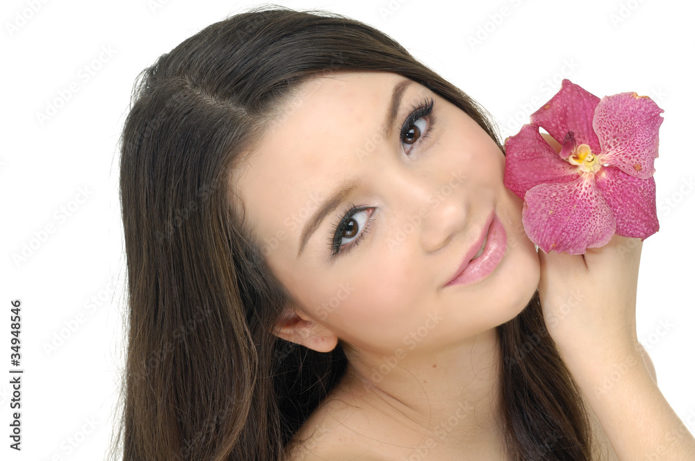 Beautiful girl holding orchid flower in her hands Beautiful girl holding orchid flower in her hands