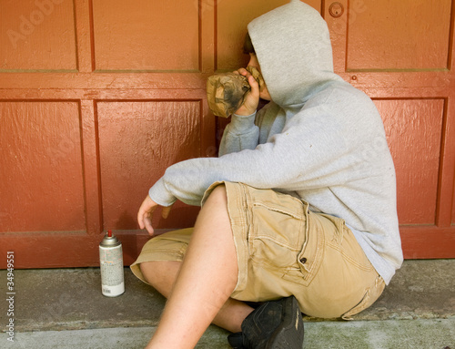 teen boy huffing - sniffing paint photo