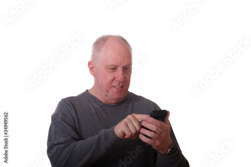 Older Balding Man in Gray Shirt Smiling Using Smart Phone