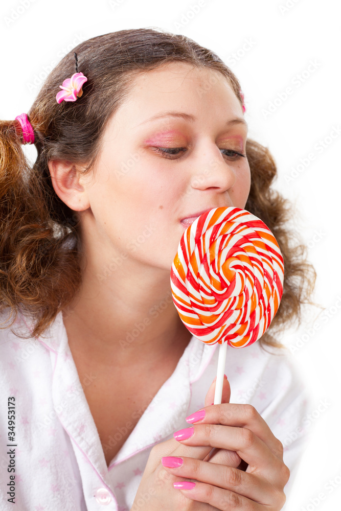 Charming girl licks tasty sugar candy tongue