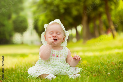 Summer portrait of beautiful baby on the lawn