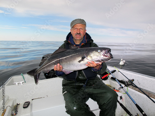 Fisherman holding a big fresh fish