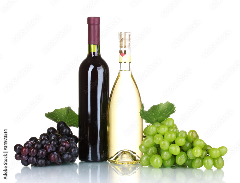 Ripe grapes and bottles of wine isolated on white