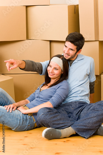 Moving new home young couple sitting floor © CandyBox Images