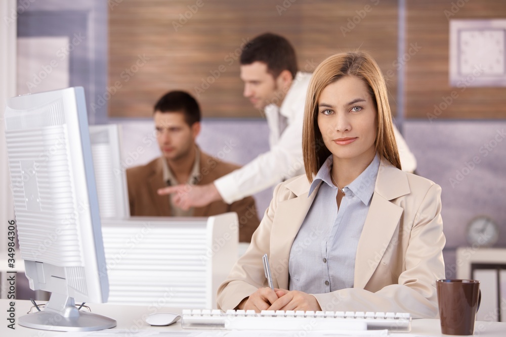 Pretty businesswoman at training course smiling Pretty businesswoman at training course smiling