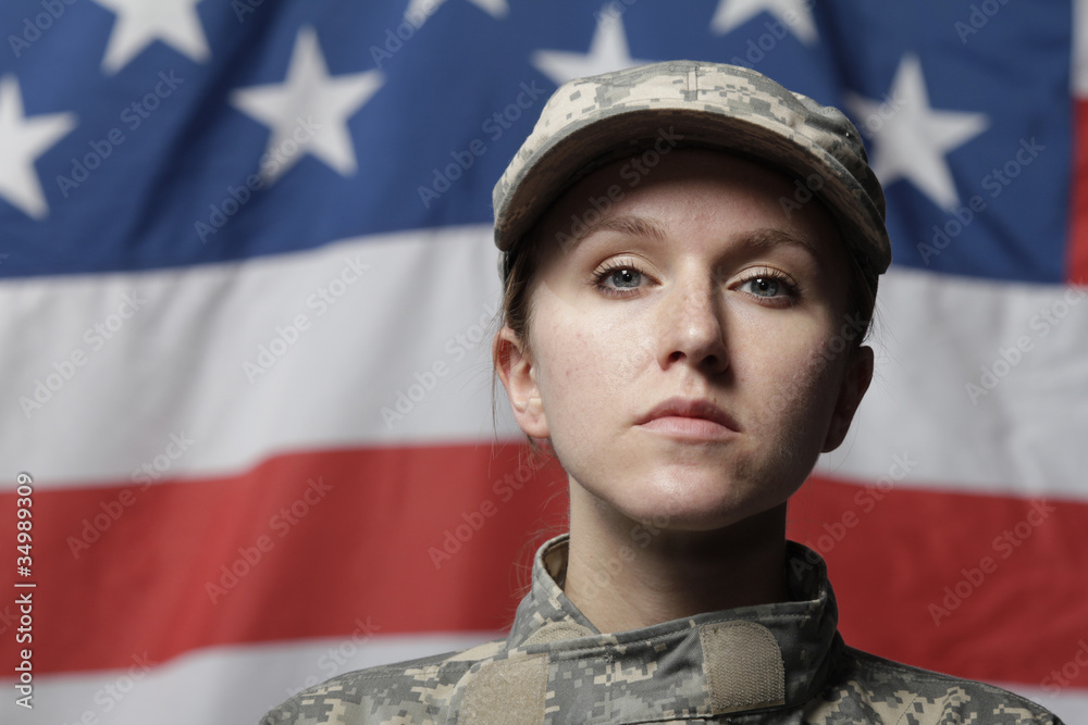 Female soldier in front of US flag Female soldier in front of US flag