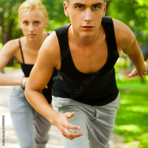 Closeup Portrait of Young Couple Jogging In Park