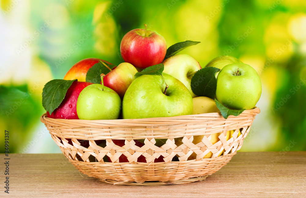 Fresh organic apples in basket on wooden table outside Fresh organic apples in basket on wooden table outside
